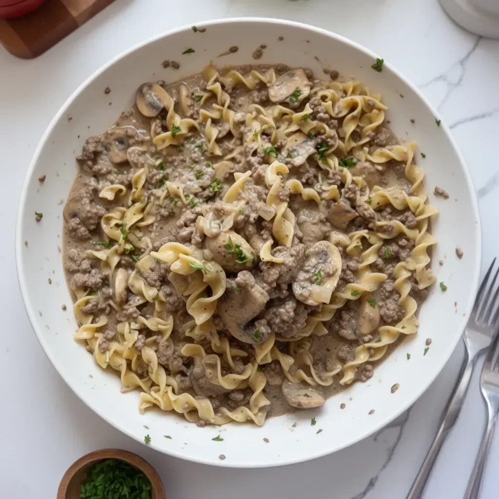 Delicious quick beef stroganoff served with egg noodles and garnished with parsley.